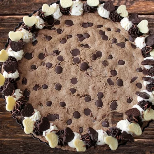 This Vegan Chocolate Chip Cookie Cake isn't just any ordinary cookie cake recipe. This is the most delicious and soft vegan chocolate chip cookie baked like a cake
